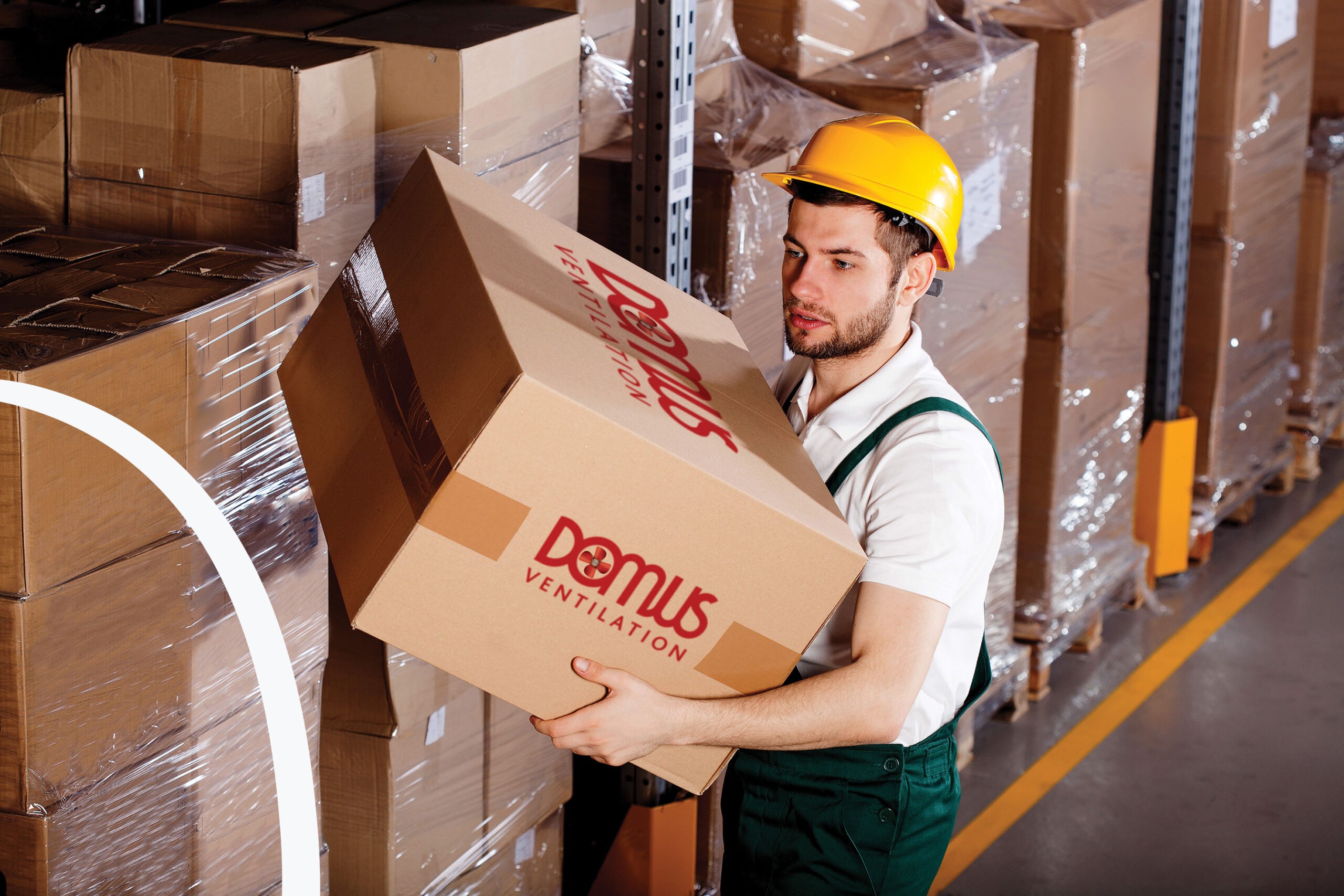 Young male worker is holding box in warehouse